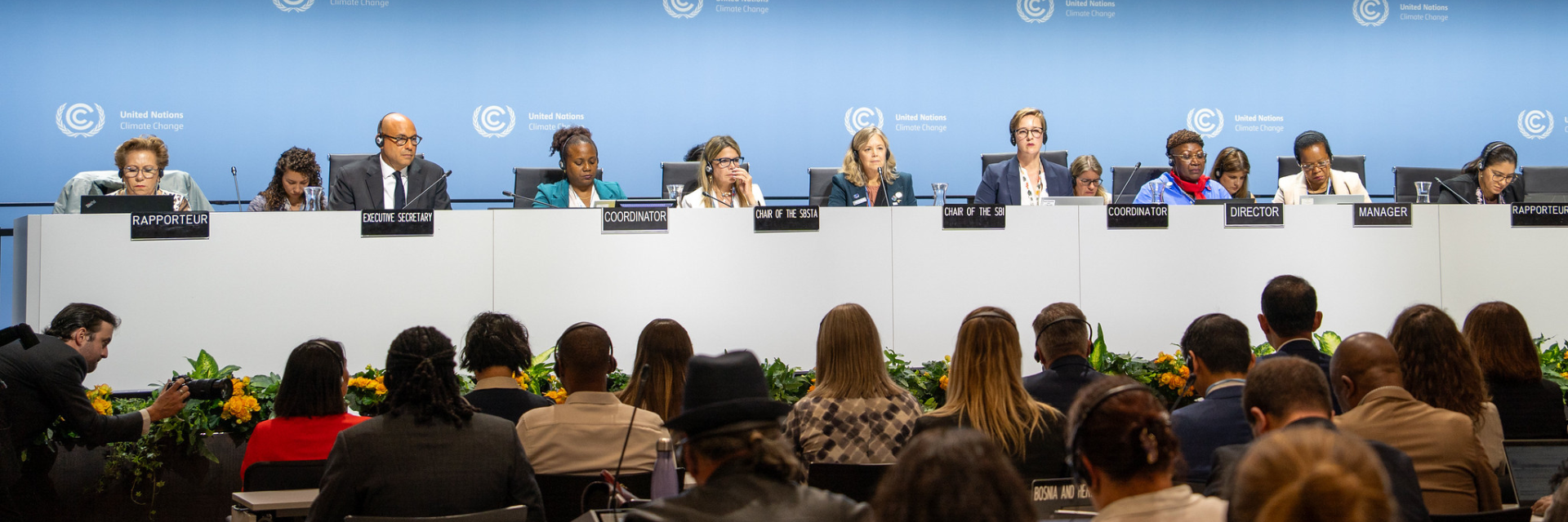 Photo of the june climate meetings with delegates sitting in front a screen that reads #JuneClimateMeetings.
